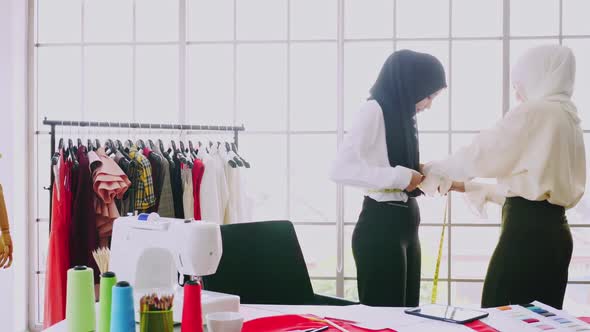 Muslim women fashion designers are in process of creating new clothes collection.