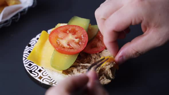 Crop cook preparing pork burger in cafe