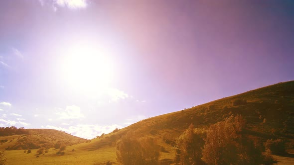  UHD Mountain Meadow Timelapse at the Summer. Clouds, Trees, Green Grass and Sun Rays Movement