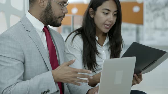 Business Colleagues with Laptop and Folder