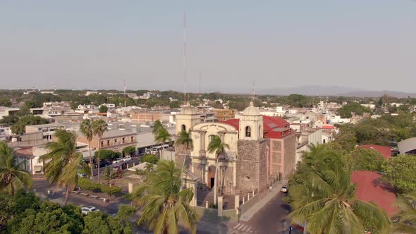 Aerial View Of Templo de la Merced From Jardin Nuñez In Colima, Mexico. - ascend