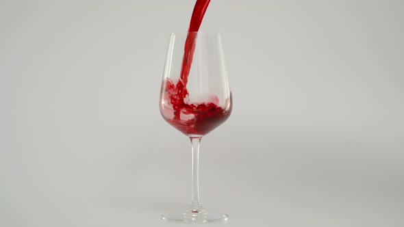 Pouring Red Wine in Glass at 1000 Fps Slow Motion Shot with White Background