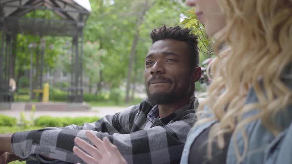 Portrait Confident Blond Woman and African American Man Talking Sitting