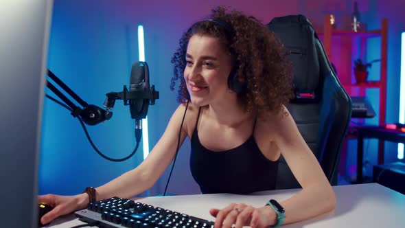 Young Woman Wearing Headphones Playing Computer Game Neon Fashion Room Winner