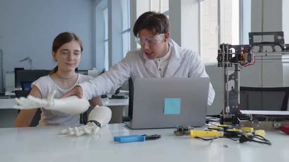 Teacher Explains on the Laptop How to Work with the 3D Printed Hand