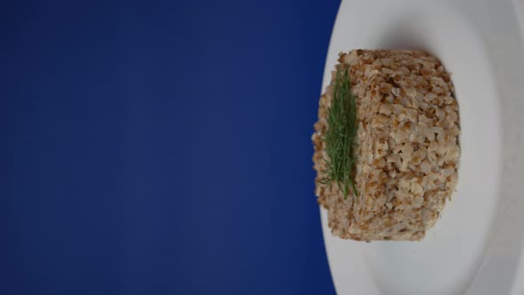 Buckwheat in a Rotating Plate on a Blue Background