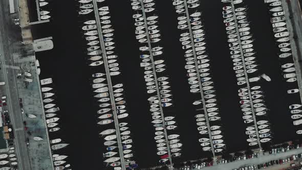 Aerial Drone Flying Out Over a Marina for Boats and Tourist Ships