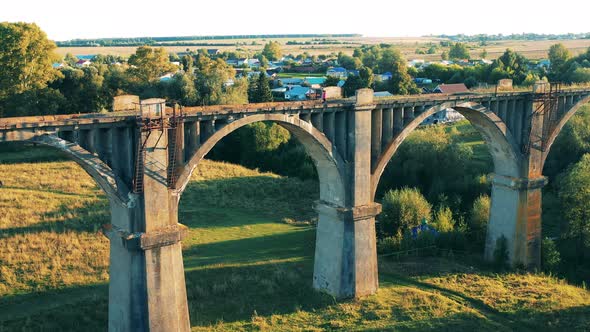 Sportswoman Is Jogging Along an Abandoned Bridge