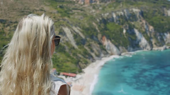 Blond Woman in Sun Glasses Looking at Beautiful Sea Bay Celebrating Scenic Landscape Enjoying