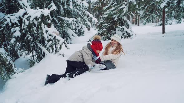 smiling children playing on snow in winter holiday