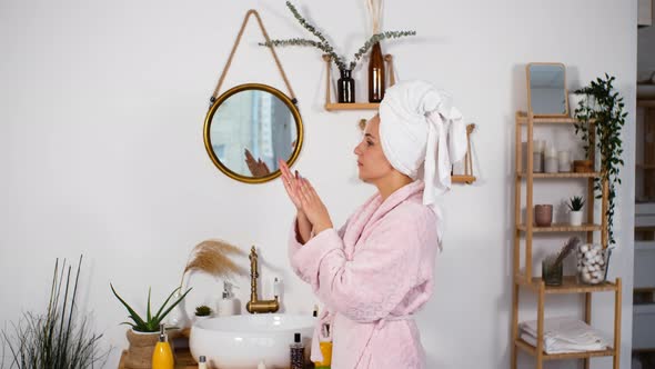 Woman Applying Hand Creme After Taking Shower