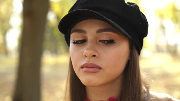 Closeup Portrait of a Beautiful Girl in a Beret Smiling Sincerely at Camera