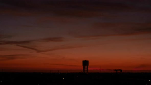 Sunset To Night - Silhouette Of Water Tank At Golden Hour In Sunset. - timelapse