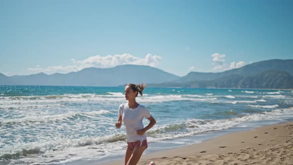 Sporty Blonde Woman Running Ocean Beach