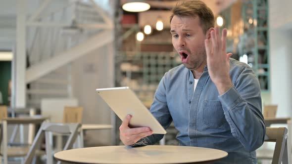 Failure Casual Man Having Loss on Tablet in Cafe
