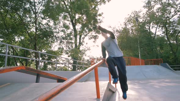 Young Man Doing Parkour Tricks in Extreme Sports Park