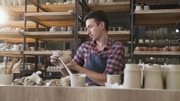 Caucasian Male Potter Making Ceramic Cap in the Pottery