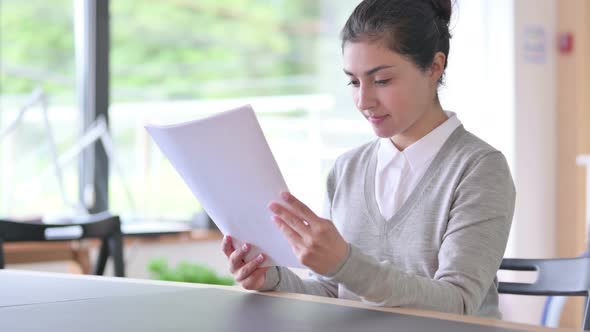 Indian Woman Reading Documents at Work 