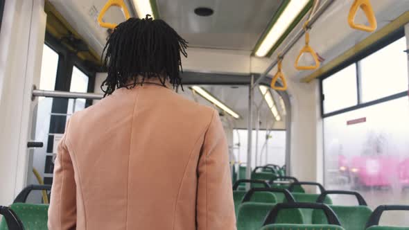 Rear View of African Man on a Public Bus