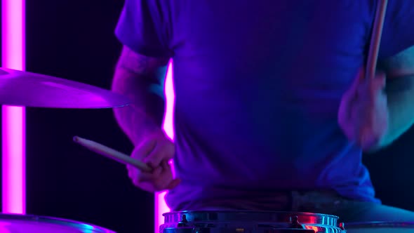 Musician Playing Drums in the Background Pink Neon Tubes