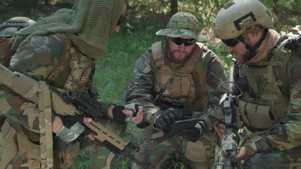 Military Men With Digital Tablet In Jungle alt