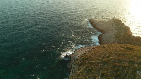 The Rocky Coast of a Greek Island at Sunset