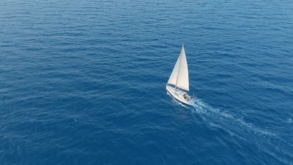 Aerial View. Yacht Sailing on Open Sea at Sunny Windy Day