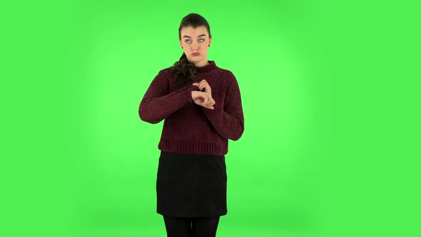 Young Woman Stands Waiting with Boredom on Green Screen.