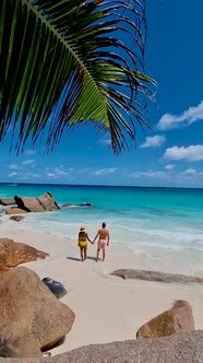 Anse Georgette Praslin Seychelles Young Couple Men and Woman on a Tropical Beach During a Luxury