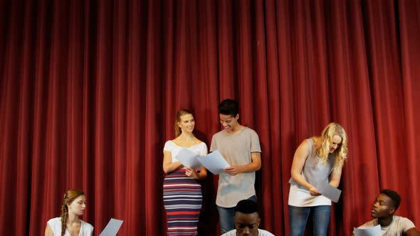 Actors reading their scripts on stage 4k