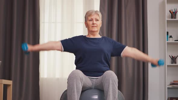 Senior Woman Exercising with Dumbbells