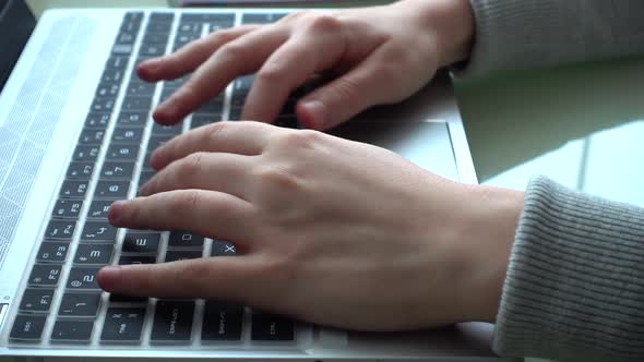 The girl working at home office hands on keyboard