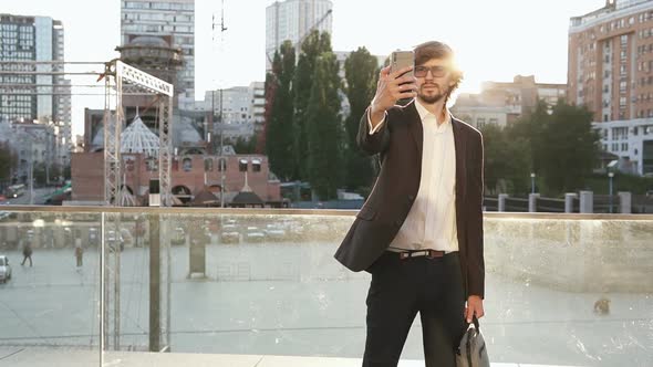 A businessman is talking via video chat with employees on the street.