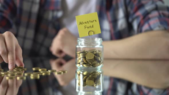 Adventure Fund Phrase Above Glass Jar With Money, Savings for Hobby, Interests