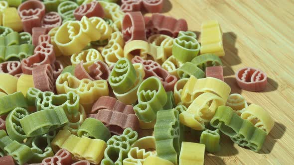 Raw pasta. Vermicelli in different colors. Pasta on a wooden background.