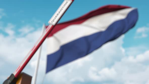 Closing Barrier with QUARANTINE Sign Against Flag of Netherlands