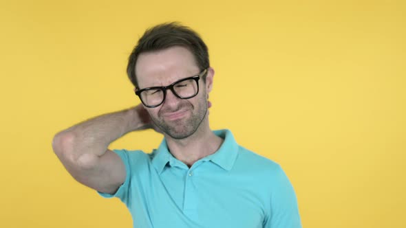 Man with Neck Pain on Yellow Background