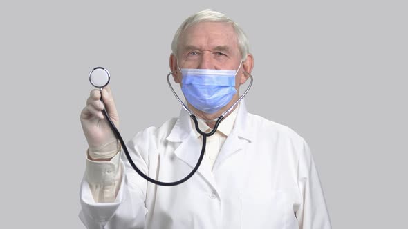 Male Old Doctor Show Stethoscope To You