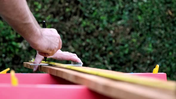 Taking Measurements in Slow Motion, Carpenter Prepares Wood for New Project, Daytime Outdoors