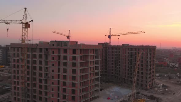 Construction Site in the Middle of the City and Private Houses at Sunset