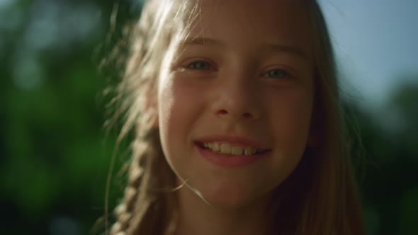 Cheerful Blond Girl Posing in Golden Sunlight