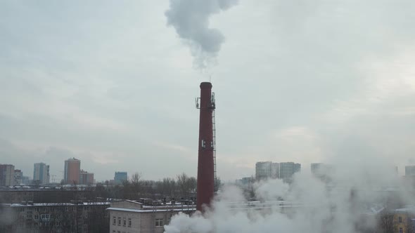 Urban High Chimney Made of Red Brick From Which Thick Smoke Pours