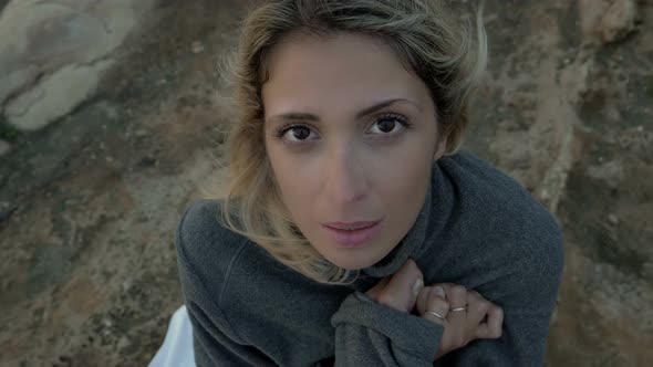 be cold: young woman on the beach during cold and windy day