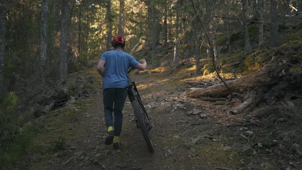 mountain biker going up a mountain with his bike ready for adventure Texada Island British Columbia