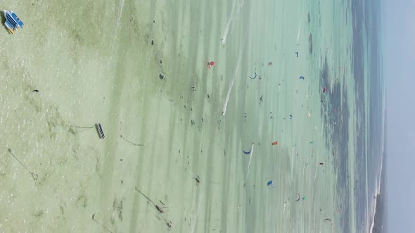 Vertical Video Kitesurfing Near the Shore of Zanzibar Tanzania Aerial View