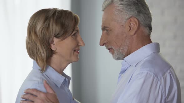 Elderly Male and Female Looking at Each Other, Putting Foreheads Together, Happy