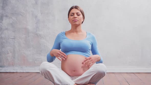 Young pregnant woman is resting at home and expecting a baby.