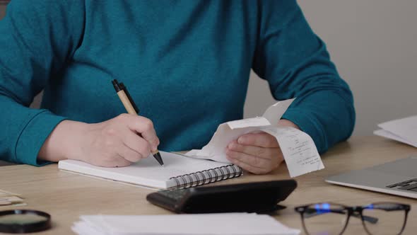 Female Woman Hands in Blue Shirt Looking Through Paper Documents Utility Bills