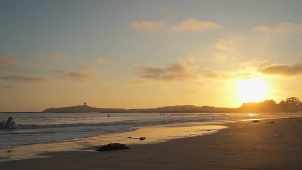 Pillar Point from El Granada, California and Cloudy Sky with a Beatiful Sunset and Surfers Riding th