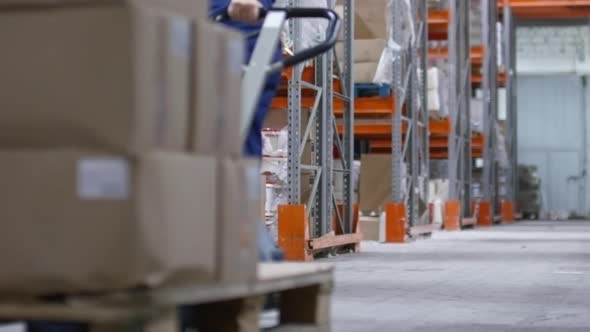 Warehouse Worker Walking with Cart